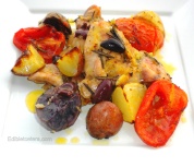 Chicken roasted with potatoes, olives, tomatoes, rosemary & lemon